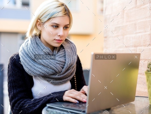 demo-attachment-40-young-focused-woman-working-on-laptop-at-outdoor-PTTFVNE